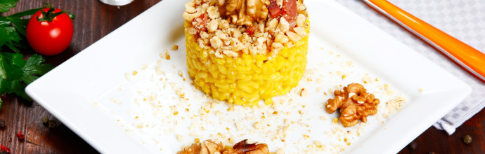 risotto with walnuts, saffron, speck on a dish