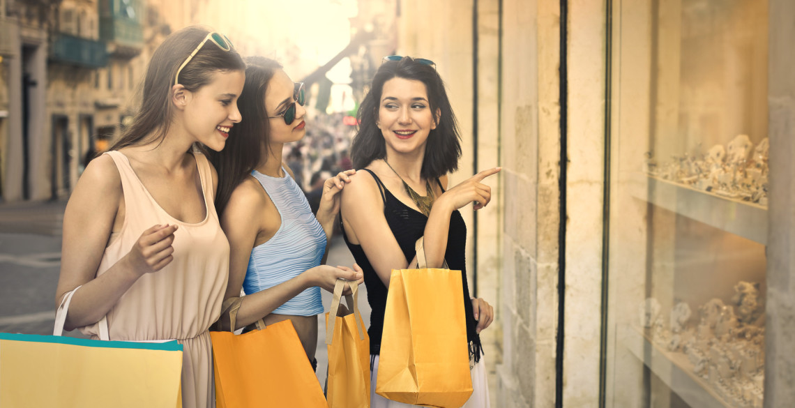 Three beautiful girls window shopping in the city